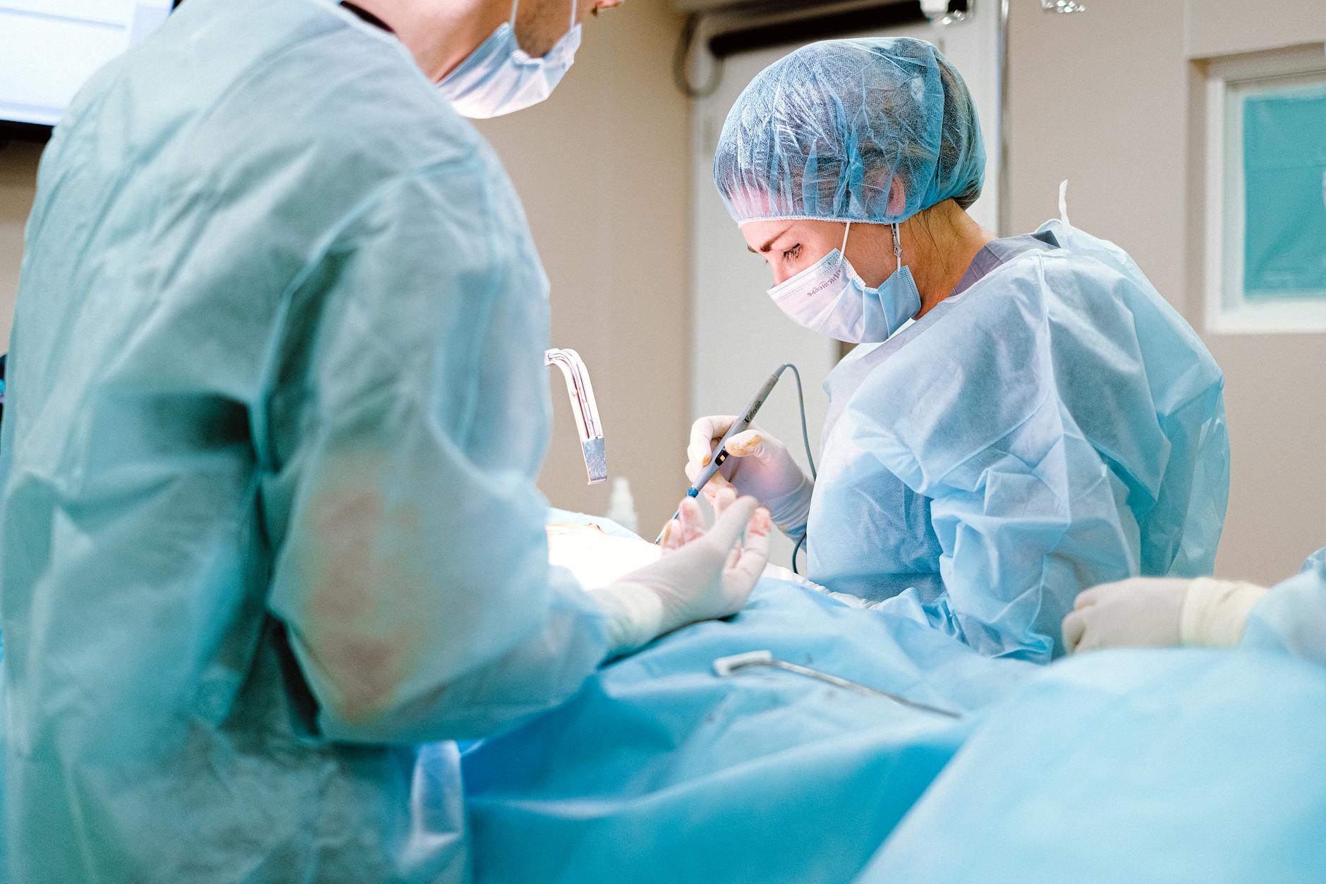 woman in blue ppe wearing blue face mask