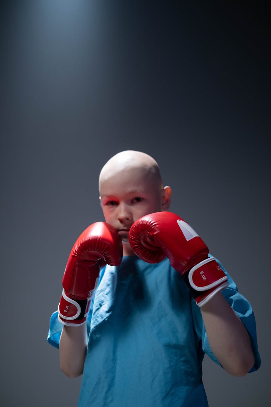 bald young person in boxing pose