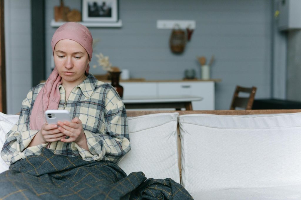 woman browsing a smartphone while sitting on the couch